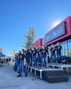 Young performers dancing and singing infront of the newly named ATCO Performing Arts Centre