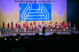 Young singers in grades 4-6 singing and performing live on the Southern Alberta Jubilee Auditorium stage